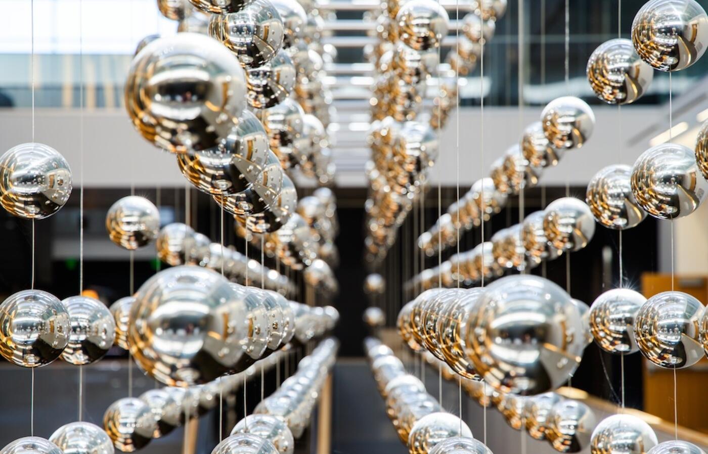 OSU campus art installation that is a system of perfectly aligned silver balls hanging from the ceiling.