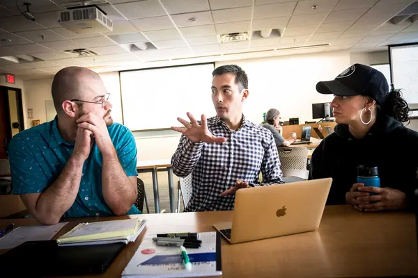 Classroom with students and teacher and laptop