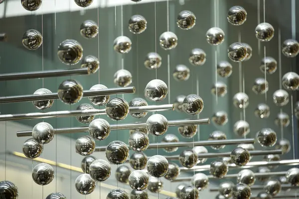 Silver rods and balls hanging.